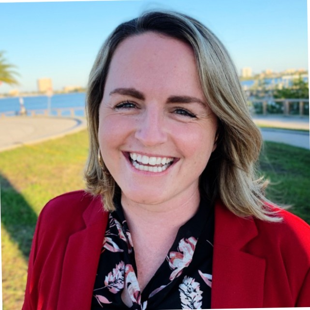 Bridget Clancy smiling in a red blazer